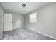 This comfortable bedroom features soft carpeting, a ceiling light, and a large window for natural light at 319 S Webster Ave, Indianapolis, IN 46219