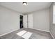 A bright bedroom with plush gray carpeting, a ceiling light, and a doorway to another room at 319 S Webster Ave, Indianapolis, IN 46219