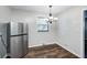 Bright dining area with modern lighting and a stainless steel refrigerator at 319 S Webster Ave, Indianapolis, IN 46219