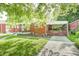 Charming brick home featuring a covered carport, inviting front porch, and well-maintained landscaping at 319 S Webster Ave, Indianapolis, IN 46219
