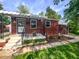Charming bungalow featuring a covered porch, brickwork, and well-kept front yard at 319 S Webster Ave, Indianapolis, IN 46219