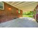 Covered patio with red brick wall and concrete flooring offering a great outdoor living space at 319 S Webster Ave, Indianapolis, IN 46219