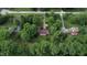 Secluded ranch home surrounded by lush trees and greenery, featuring a long driveway and large lawn at 3711 Tara Ct, Carmel, IN 46074