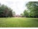 A home's backyard features a large lawn and mature trees at 3711 Tara Ct, Carmel, IN 46074