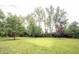 Large, well-maintained backyard with mature trees offers a private and serene outdoor space at 3711 Tara Ct, Carmel, IN 46074