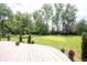 A spacious backyard offers a deck, a big lawn and mature trees at 3711 Tara Ct, Carmel, IN 46074