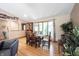 Inviting dining area featuring hardwood floors, a rustic wooden table, and large windows at 3711 Tara Ct, Carmel, IN 46074