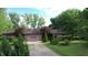Charming ranch home features a brick facade, attached garage, and lush landscaping at 3711 Tara Ct, Carmel, IN 46074