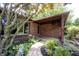 Charming brick home with a covered entrance and a beautifully landscaped front garden and mature tree at 3711 Tara Ct, Carmel, IN 46074
