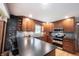 Kitchen featuring modern stainless steel appliances, dark countertops, and stylish tile backsplash at 3711 Tara Ct, Carmel, IN 46074