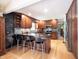Eat-in kitchen with wood cabinets, stainless steel appliances, dark countertops, and a chalkboard accent wall at 3711 Tara Ct, Carmel, IN 46074