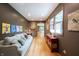 Cozy sitting room with a large window, hardwood floors, couch, and colorful accent paintings at 3711 Tara Ct, Carmel, IN 46074