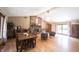 Open living room and dining area with hardwood floors, a brick fireplace, and large windows for natural light at 3711 Tara Ct, Carmel, IN 46074
