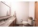 A well-lit powder room features granite counters and tiled floors at 3711 Tara Ct, Carmel, IN 46074