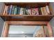 A charming collection of books displayed on a wooden shelf above a doorway at 3711 Tara Ct, Carmel, IN 46074
