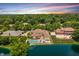 Stunning aerial view of a luxurious home with a pool and lake in a lush, green, tree-lined neighborhood at 3893 Bent Tree Ln, Greenwood, IN 46143