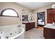 Bright bathroom featuring tile floors, soaking tub, and vanity at 3893 Bent Tree Ln, Greenwood, IN 46143