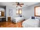 Charming bedroom features hardwood floors, two twin beds, and a ceiling fan at 3893 Bent Tree Ln, Greenwood, IN 46143