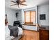 Bedroom with hardwood floors, a window seat, a ceiling fan, and a desk at 3893 Bent Tree Ln, Greenwood, IN 46143