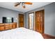Spacious bedroom with hardwood floors, modern ceiling fan, and adjoining bath at 3893 Bent Tree Ln, Greenwood, IN 46143