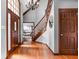 Grand foyer with hardwood floors, staircase, and chandelier creating an inviting entrance at 3893 Bent Tree Ln, Greenwood, IN 46143