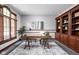Cozy home office featuring a wooden desk, custom shelving, and ample natural light for a productive workspace at 3893 Bent Tree Ln, Greenwood, IN 46143