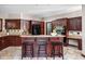 Well-equipped kitchen with dark wood cabinetry, granite countertops, modern appliances, and a breakfast bar at 3893 Bent Tree Ln, Greenwood, IN 46143