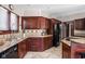Spacious kitchen features tile floors, dark wood cabinets, and stainless steel appliances at 3893 Bent Tree Ln, Greenwood, IN 46143