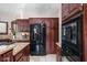 Modern kitchen with dark wood cabinets, stainless steel appliances, and granite countertops at 3893 Bent Tree Ln, Greenwood, IN 46143