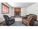 Basement living area featuring a brick fireplace, plush seating, and neutral decor at 3893 Bent Tree Ln, Greenwood, IN 46143