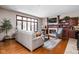 Inviting living room with a fireplace, large window, comfortable seating, and hardwood flooring at 3893 Bent Tree Ln, Greenwood, IN 46143
