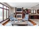 Cozy living room featuring a fireplace, large windows, comfortable seating, and stylish decor at 3893 Bent Tree Ln, Greenwood, IN 46143