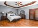 Main bedroom featuring hardwood floors, tray ceiling, and decorative trim at 3893 Bent Tree Ln, Greenwood, IN 46143