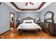 Main bedroom featuring hardwood floors, tray ceiling, and decorative trim at 3893 Bent Tree Ln, Greenwood, IN 46143