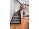 Elegant staircase featuring hardwood treads and decorative lighting, leading to the upper level at 3893 Bent Tree Ln, Greenwood, IN 46143
