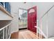 Inviting entryway with a decorative security door, red front door, and natural light at 4020 Eisenhower Dr, Indianapolis, IN 46254