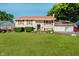 Charming split-level home featuring a spacious lawn, manicured bushes, and a red roof that adds character to the residence at 4020 Eisenhower Dr, Indianapolis, IN 46254