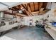 Spacious garage with overhead lighting and storage shelves, offering ample space for parking and organization at 4020 Eisenhower Dr, Indianapolis, IN 46254