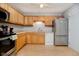 Kitchen with light wood cabinets, stainless steel appliances, and durable flooring at 4020 Eisenhower Dr, Indianapolis, IN 46254