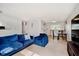 Bright living room with plush blue seating, neutral walls, and adjacent dining area at 4020 Eisenhower Dr, Indianapolis, IN 46254