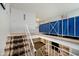 Spacious stairwell with brown carpet and white railing, leading to an open living area below at 4020 Eisenhower Dr, Indianapolis, IN 46254