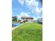 Back exterior of a home overlooking a large grassy backyard with covered pool at 430 N Greenbriar Dr, Greenwood, IN 46142