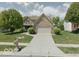 Charming two-story brick home with a well-maintained front yard and attached two car garage at 430 N Greenbriar Dr, Greenwood, IN 46142