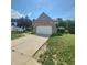 Well maintained two-story brick home with an attached two-car garage and manicured lawn at 430 N Greenbriar Dr, Greenwood, IN 46142