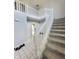 Elegant staircase with white railings and neutral carpeting leads to the upper level at 430 N Greenbriar Dr, Greenwood, IN 46142