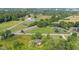 Property aerial view showcasing a barn, pond, train tracks and neighborhood including swimming pools at 4305 Five Points Rd, Indianapolis, IN 46239