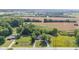 Aerial view of home nestled among greenery, with open agricultural fields and power lines at 4305 Five Points Rd, Indianapolis, IN 46239