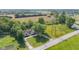 Aerial view of home with a paved driveway, surrounded by green grass and trees at 4305 Five Points Rd, Indianapolis, IN 46239