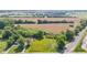 Expansive aerial view of property featuring open fields, lush trees, and convenient train track access at 4305 Five Points Rd, Indianapolis, IN 46239