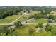 Aerial view highlighting property features including a barn, pond, train tracks, and nearby residences at 4305 Five Points Rd, Indianapolis, IN 46239